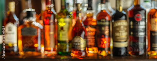 Beautiful bokeh from a row of alcoholic bottles in backlight.