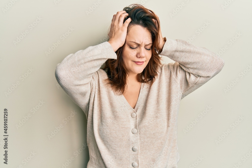 Young caucasian woman wearing casual clothes suffering from headache desperate and stressed because pain and migraine. hands on head. Young caucasian woman wearing casual clothes suffering from headache desperate and stressed because pain and migraine. hands on head.