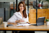 Portrait of Beautiful young smiling Asian entrepreneur businesswoman working whit laptop computer in modern office.