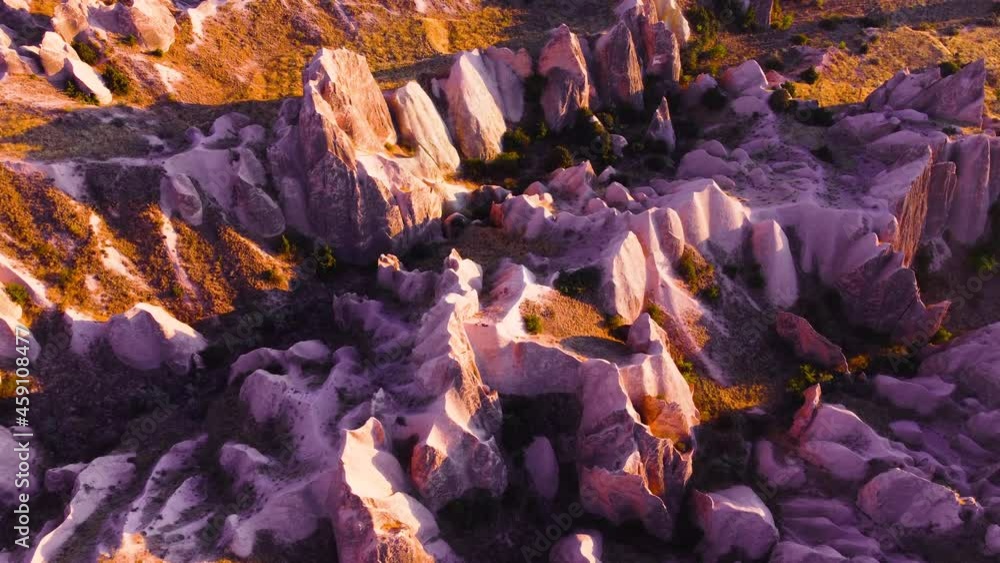 Famous Pink Valley At Sunset, Gulludere in Cappadocia, Turkey. Colourful Mountains, Birds eye view 4k aerial drone landscape. Red and Pink Rocks, Dramatic geological wonder. Famous Pink Valley At Sunset, Gulludere in Cappadocia, Turkey. Colourful Mountains, Birds eye view 4k aerial drone landscape. Red and Pink Rocks, Dramatic geological wonder.