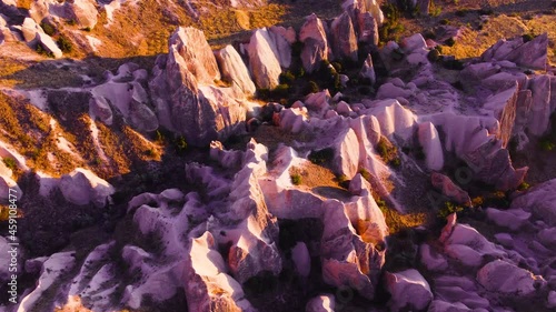 Famous Pink Valley At Sunset, Gulludere in Cappadocia, Turkey. Colourful Mountains, Birds eye view 4k aerial drone landscape. Red and Pink Rocks, Dramatic geological wonder. photo