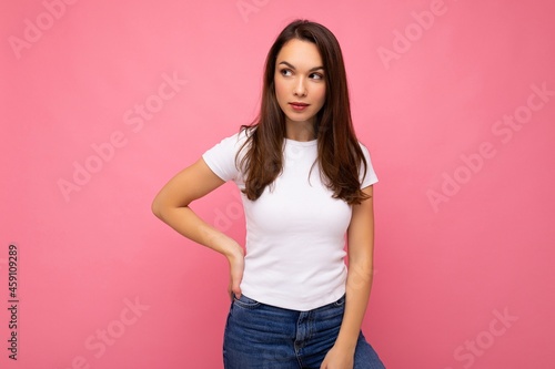Photo shot of cute nice charming gorgeous attractive pretty youngster happy woman wearing white t-shirt for mockup isolated over colorful background with copy space