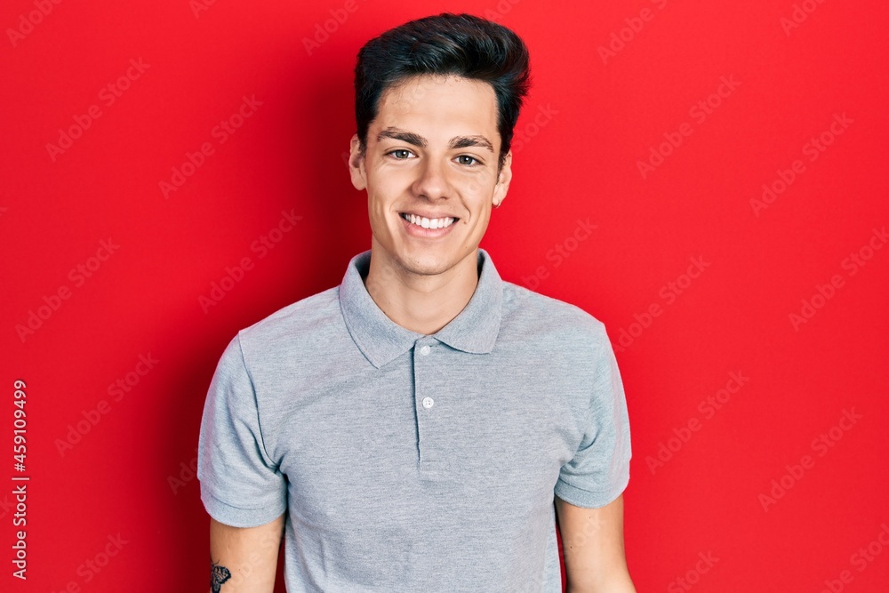 Young hispanic man wearing casual clothes with a happy and cool smile on face. lucky person. Young hispanic man wearing casual clothes with a happy and cool smile on face. lucky person.