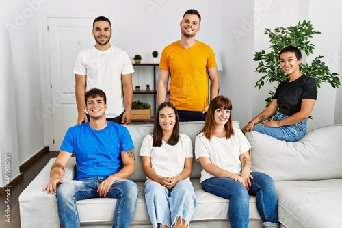 Group of young friends smiling happy sitting on the sofa at home.