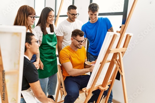 Group of people smiling happy and looking draw of partner at art studio.