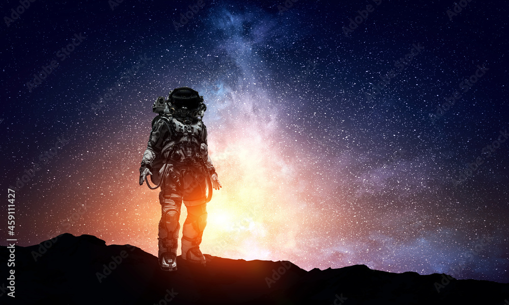 Astronaut walking on an unexplored planet Astronaut walking on an unexplored planet