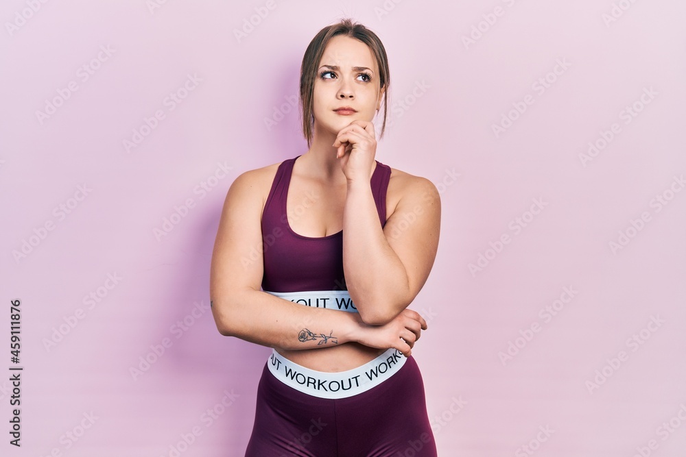 Young hispanic girl wearing sportswear thinking concentrated about doubt with finger on chin and looking up wondering Young hispanic girl wearing sportswear thinking concentrated about doubt with finger on chin and looking up wondering