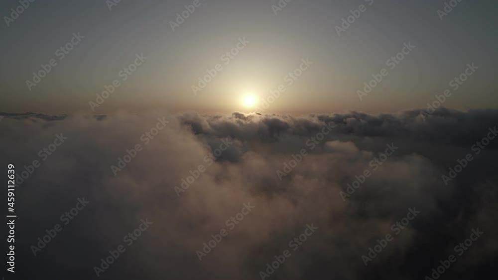 Fly through the clouds during sunrise. An epic shot of clouds in morning colors. Fly through the clouds during sunrise. An epic shot of clouds in morning colors.