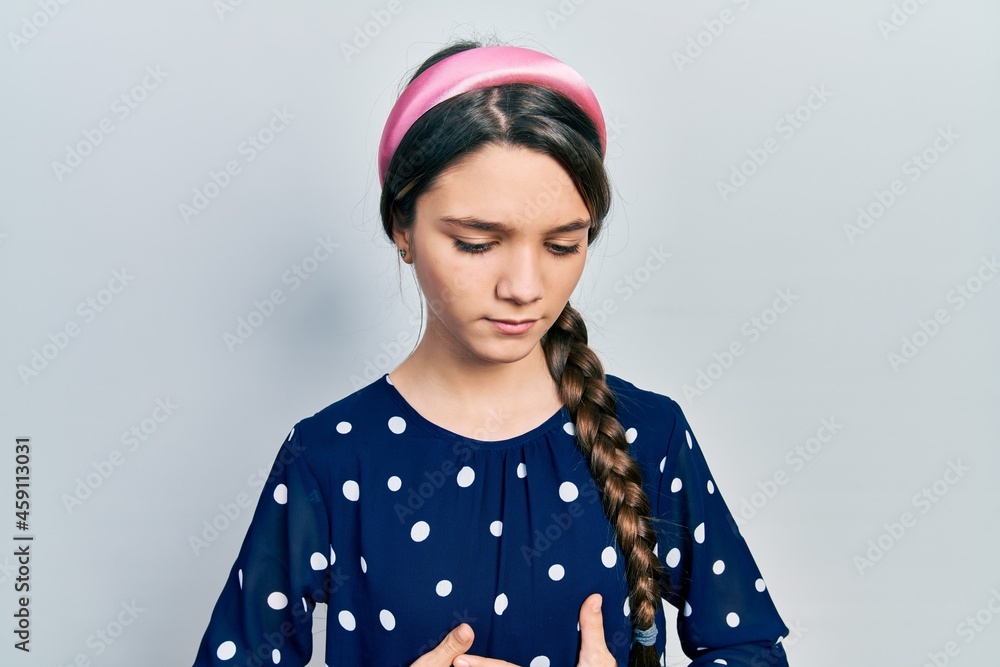 Young brunette girl wearing elegant look with hand on stomach because indigestion, painful illness feeling unwell. ache concept. Young brunette girl wearing elegant look with hand on stomach because indigestion, painful illness feeling unwell. ache concept.