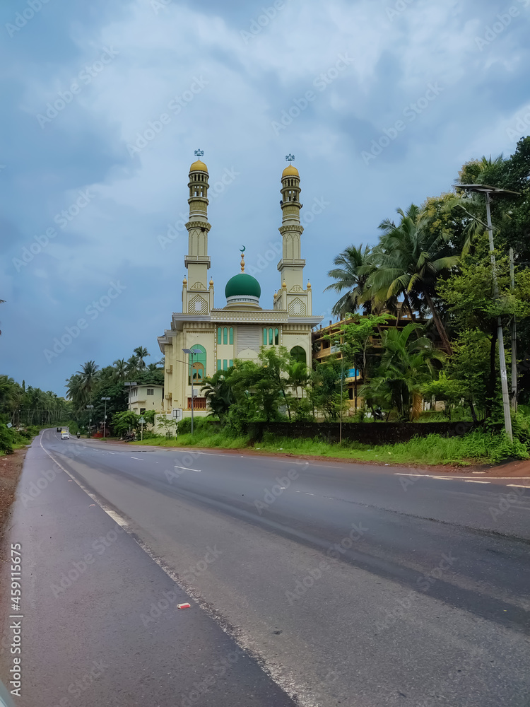 Traditional mosque exterior architecture near the road under the sky. Muslim religion spiritual place for pray in Kerala state India.