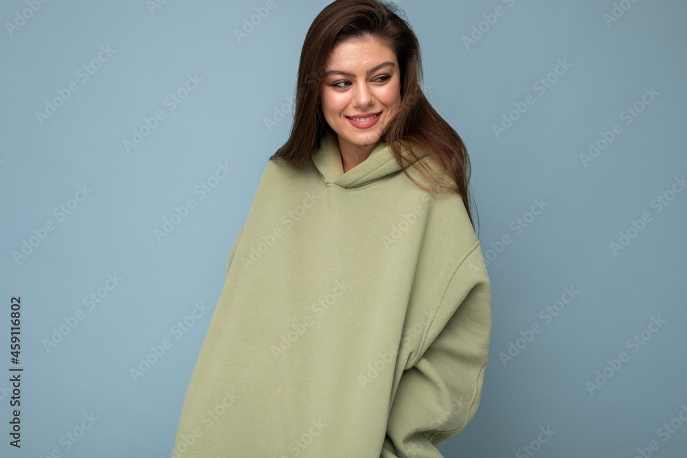 Attractive young woman in a khaki hoodie. Mock-up. Copy space Attractive young woman in a khaki hoodie. Mock-up. Copy space