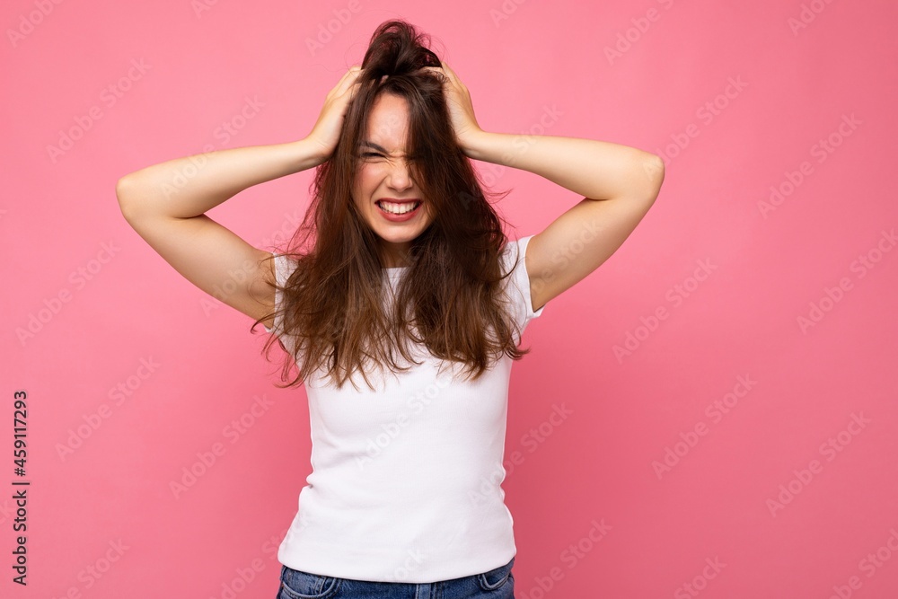 Portrait of positive cheerful fashionable woman in casual white t-shirt for mock up isolated on pink background with copy space Portrait of positive cheerful fashionable woman in casual white t-shirt for mock up isolated on pink background with copy space
