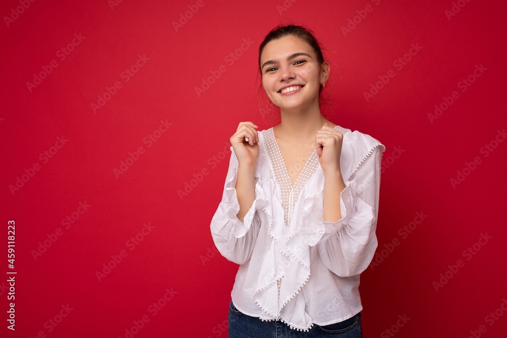 Photo portrait of beautiful smiling happy funny young brunette woman in stylish white blouse. Sexy carefree female person posing isolated on red background. Positive model shows sincere emotions Photo portrait of beautiful smiling happy funny young brunette woman in stylish white blouse. Sexy carefree female person posing isolated on red background. Positive model shows sincere emotions