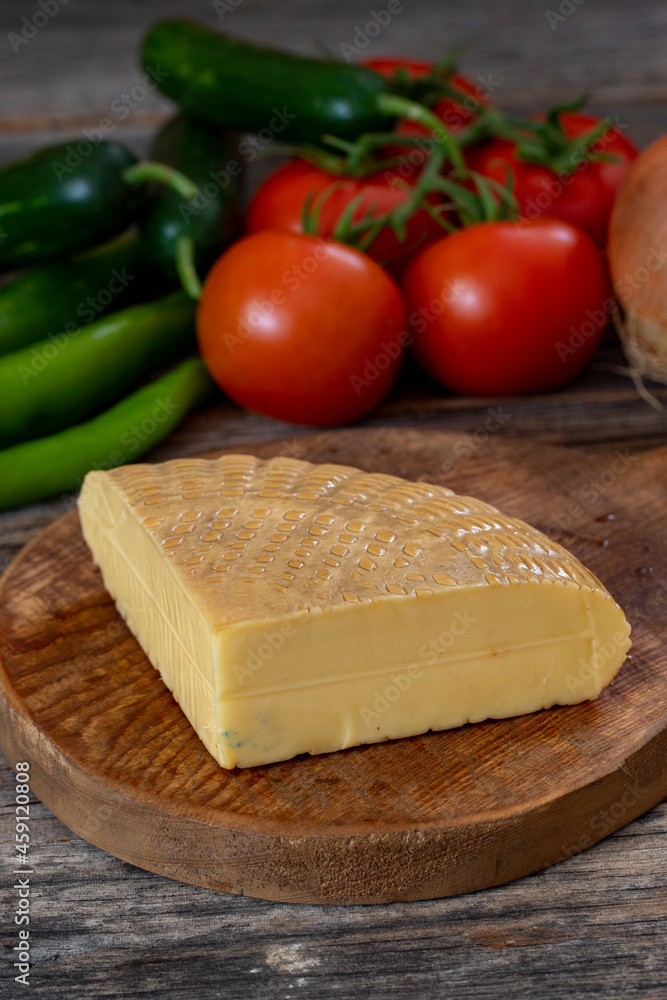 Smoked cheese on wood background Smoked cheese on wood background