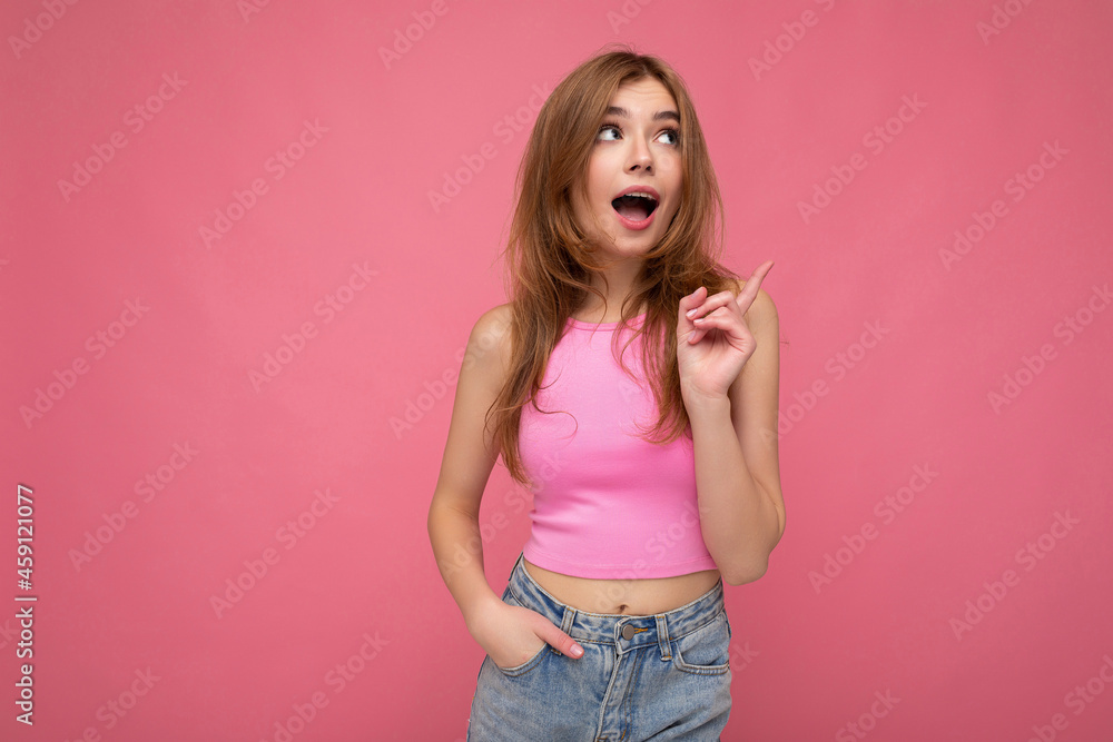 Young thoughtful beautiful dark blonde woman with sincere emotions isolated on background wall with copy space wearing stylish pink top. Idea concept Young thoughtful beautiful dark blonde woman with sincere emotions isolated on background wall with copy space wearing stylish pink top. Idea concept