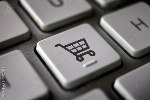 Image of shopping cart on computer keyboard, close up