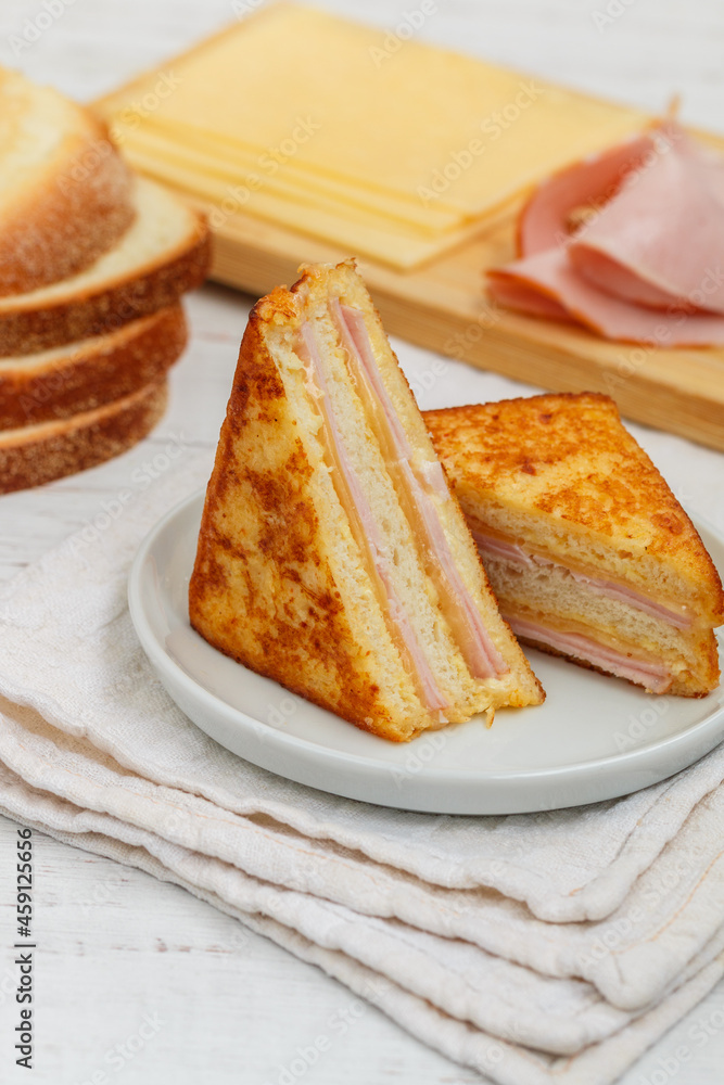 Traditional homemade Monte Cristo sandwich with ham and cheese on a white background. Breakfast, brunch. Selective focus Traditional homemade Monte Cristo sandwich with ham and cheese on a white background. Breakfast, brunch. Selective focus