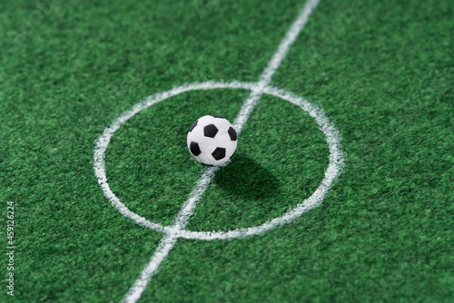 Black and white soccer ball in the center of the soccer field, decoration mini football.