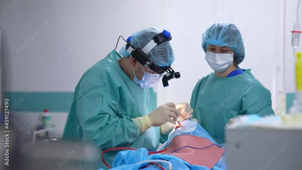 Medical nasal procedure in the operating room. Professional doctor and assistant perform a surgery in patient's nose using surgical tools. Medical nasal procedure in the operating room. Professional doctor and assistant perform a surgery in patient's nose using surgical tools.