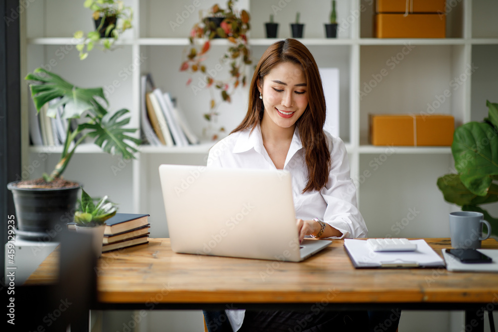 Portrait of beautiful asian young Business woman working audit and calculating expense annual financial report balance sheet statement,doing finance making notes on paper graph data checking document.
