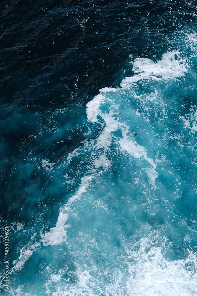 Aerial view to seething waves with foam. Waves of the sea meet each other during high tide and low tide Aerial view to seething waves with foam. Waves of the sea meet each other during high tide and low tide