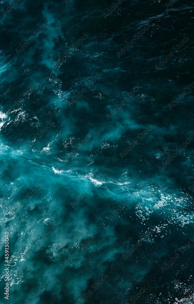 Aerial view to seething waves with foam. Waves of the sea meet each other during high tide and low tide