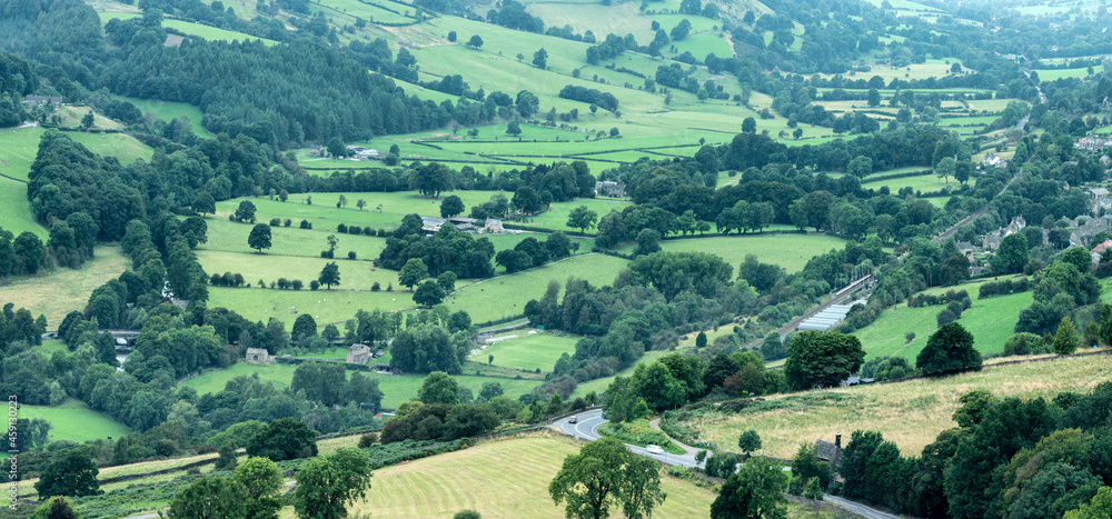 Panorama landscape image of Peak District National Park valley in English countryside during late Summer hazy evening Panorama landscape image of Peak District National Park valley in English countryside during late Summer hazy evening