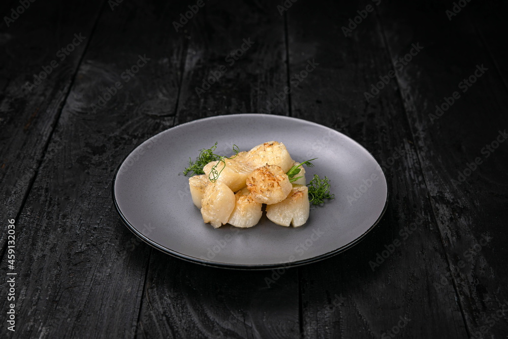 grilled seafood in a gray round plate on a dark wooden table
grilled seafood in a gray round plate on a dark wooden table