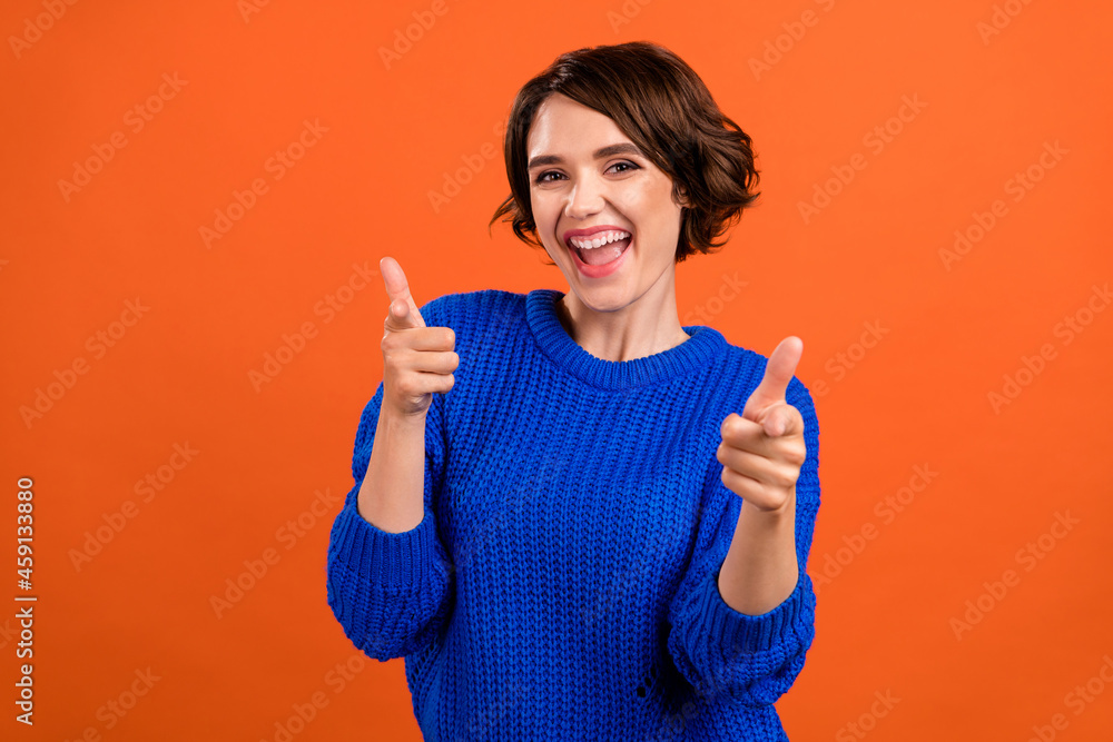 Photo portrait bob haired woman smiling pointing fingers selecting you isolated vivid orange color background Photo portrait bob haired woman smiling pointing fingers selecting you isolated vivid orange color background
