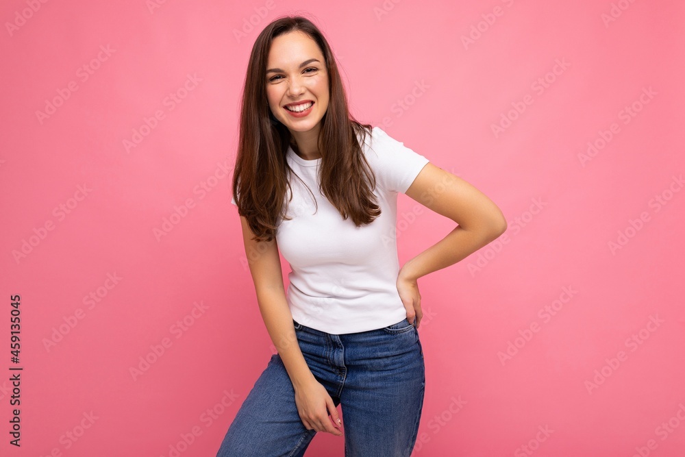 Portrait of positive cheerful fashionable woman in casual t-shirt for mock up isolated on pink background with copy space Portrait of positive cheerful fashionable woman in casual t-shirt for mock up isolated on pink background with copy space