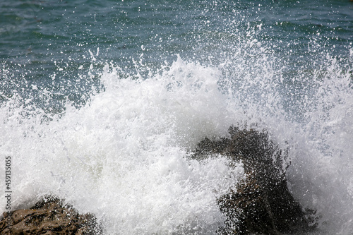 Waves Crash onto a Giant Boulder and Leave a Foamy Splash on the California Rugged Coast