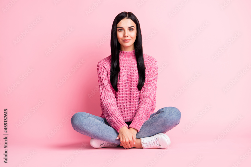 Full body portrait of adorable satisfied lady sit floor lotus pose look camera isolated on pink color background Full body portrait of adorable satisfied lady sit floor lotus pose look camera isolated on pink color background