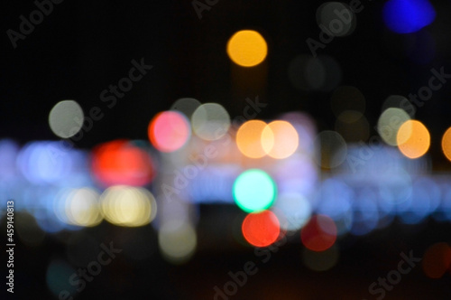 blurred lights of the night city red blue yellow on a black background festive mood bright abstraction background on the desktop © Вадим Шаповал
