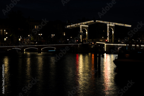 The famous wooden bascule bridge "Magere Brug" over the river Amstel in Amsterdam at night