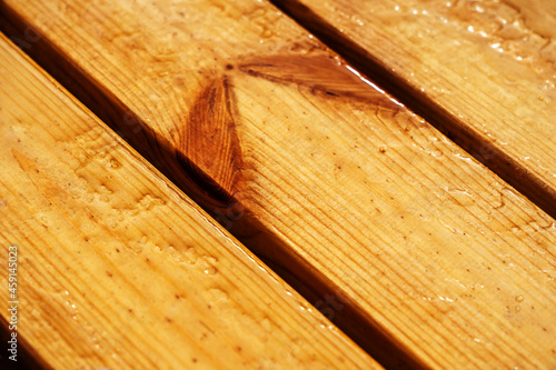 Wooden boards treated with a moisture-proof coating. Timber blotting and water repellency test. Close-up