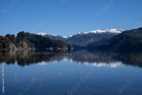 Beauty in nature. View of volcano Batea Mahuida, Andes mountains, forest and Alumine lake in Villa Pehuenia, Patagonia Argentina. Beautiful landscape and blue sky reflection in the glacier water. 