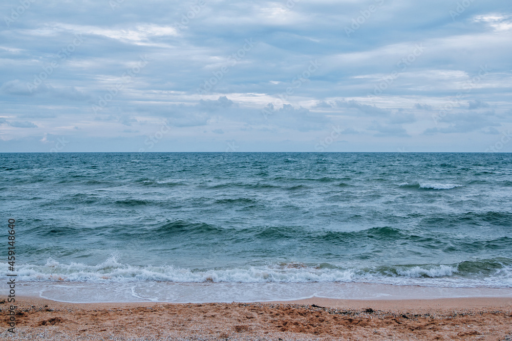 Landscape with stormy sea - waving water and foam - wave, covering sandy beach. Landscape with stormy sea - waving water and foam - wave, covering sandy beach.