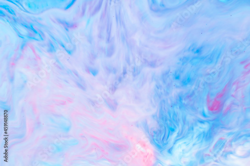 Fluid Art. Abstract liquid paint textured background with decorative spirals and swirls. Liquid pink blue backdrop. Trendy wallpaper