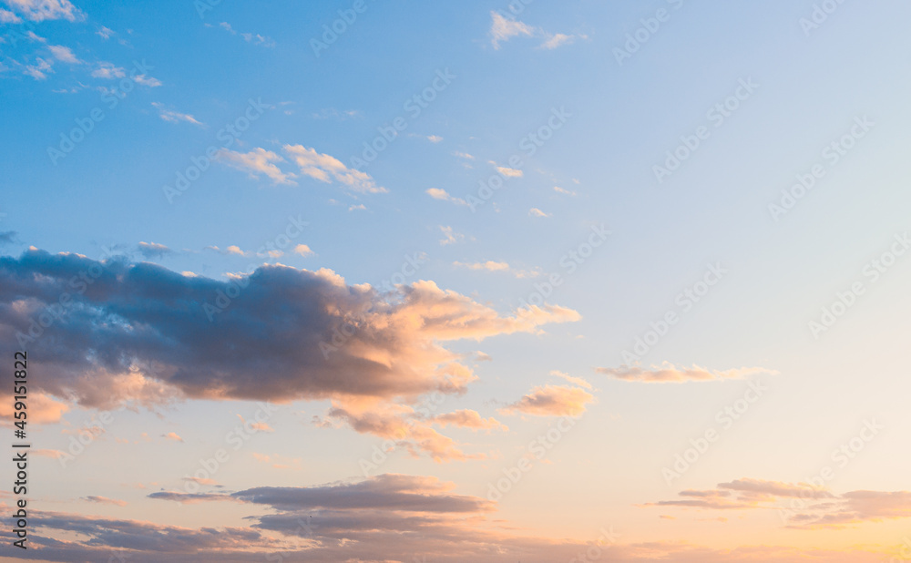 fluffy clouds on a sunset background with dramatic light.