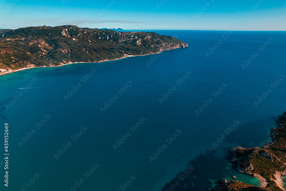 Aerial drone view to seascape with clear blue water. Amazing azure Mediterranean coast background. Travel destination, universal nature, resort, summer vacation. 