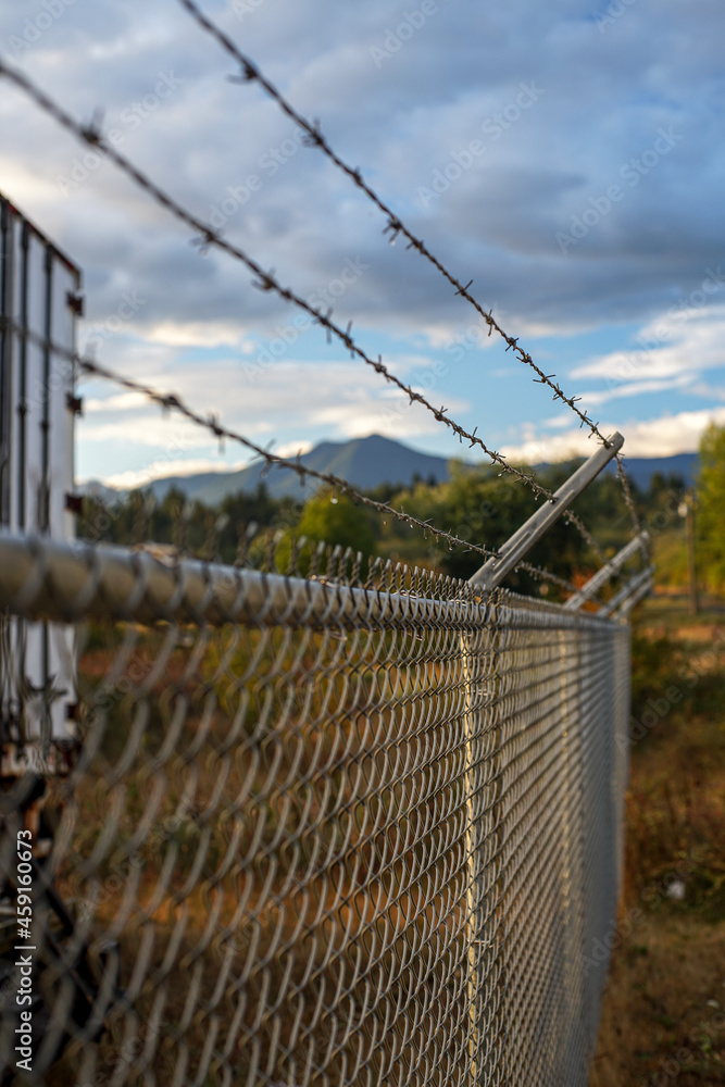 Chain link fence with barbed wire. Chain link fence with barbed wire.