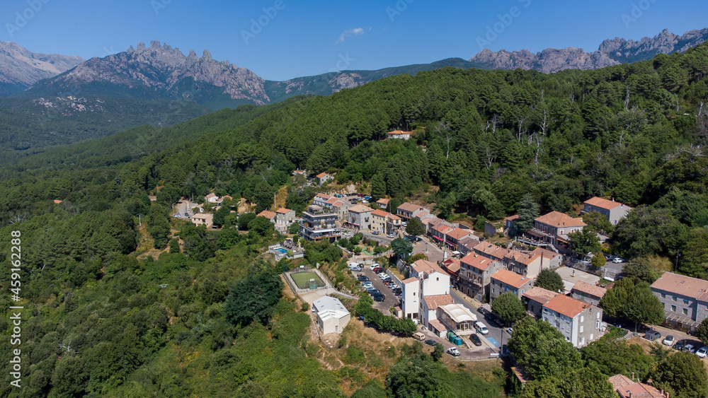 Aerial view of the mountainous village of Zonza in the South of Corsica, France, with the Peaks of Bavella in the background