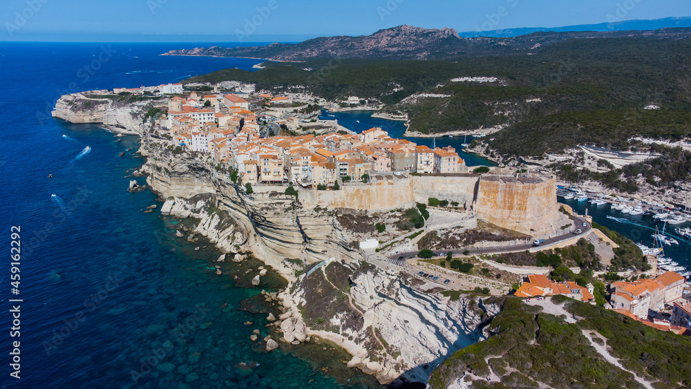 Aerial view of the medieval city of Bonifacio, built on a cape in the south of the island of Corsica in France - Old houses and citadel perched on a limestone promontory
