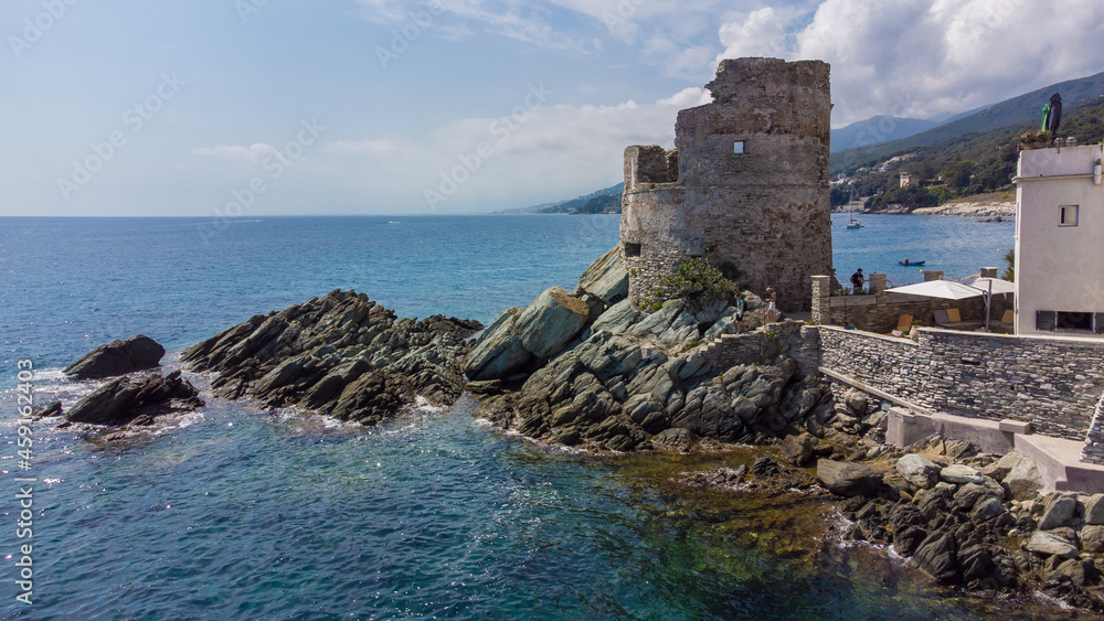 Aerial view of Erbalunga, a small fishing village on the Corsican Cape, France - Ruins of a Genoese Tower at the tip of a rocky cape in the Mediterranean Sea