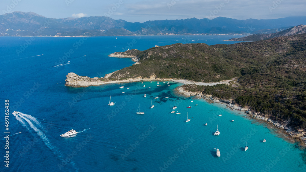 Aerial view of the Cavallata Tip in the Agriates Desert northwest of Saint Florent near the Cap Corse, Corsica, France - Leisure boats moored by the Small Lotu Beach