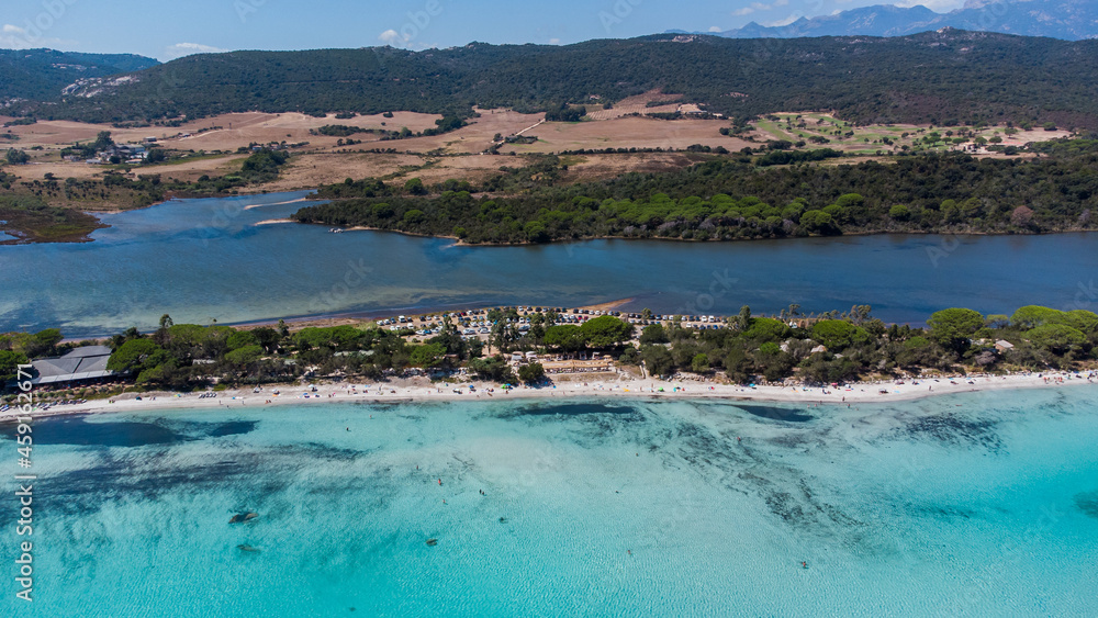 Aerial view of the sand strip between the beach and the pond of Santa Giulia in the South of Corsica, France - Separation between fresh and sea water of different colors Aerial view of the sand strip between the beach and the pond of Santa Giulia in the South of Corsica, France - Separation between fresh and sea water of different colors