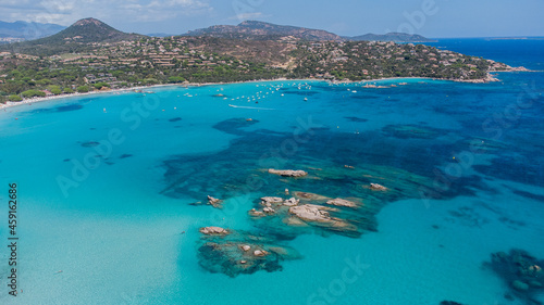 Aerial view of some sea rocks in the bay of Santa Giulia in the South of Corsica, France - Beach with shallow turquoise waters near Porto Vecchio in the Mediterranean Sea