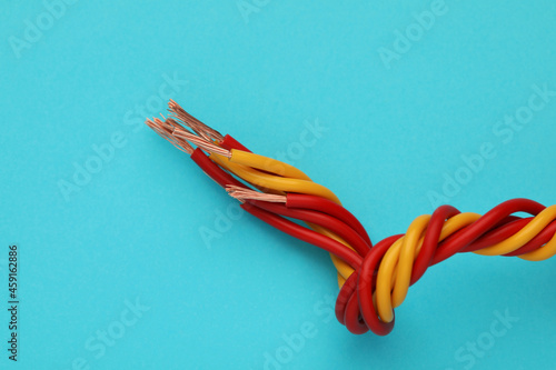 Electrical wires on light blue background, closeup