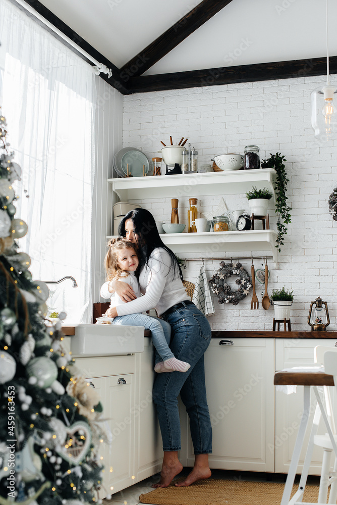 Mom and Little Daughter are preparing for the holiday and playing. Family, happiness. Mom and Little Daughter are preparing for the holiday and playing. Family, happiness.