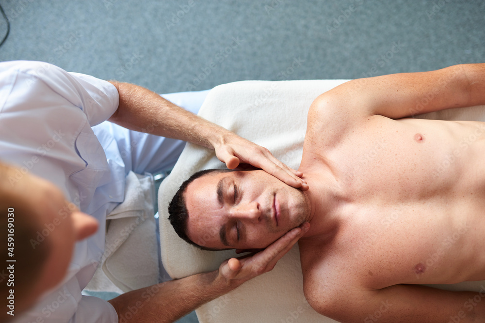 Man relaxing from face massage